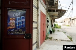 Advertising sign is seen at a liquor shop, after it was banned during the Islamic State militants' seizure of the city, in Mosul, Iraq, April 18, 2019.