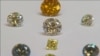 FILE - A still image from video shows coloured synthetic diamonds on display at De Beers' International Institute of Diamond Grading and Research in Maidenhead, Aug. 15, 2016. 
