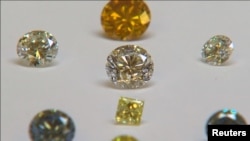 FILE - A still image from video shows colored synthetic diamonds on display at De Beers' International Institute of Diamond Grading and Research, August 15, 2016. 