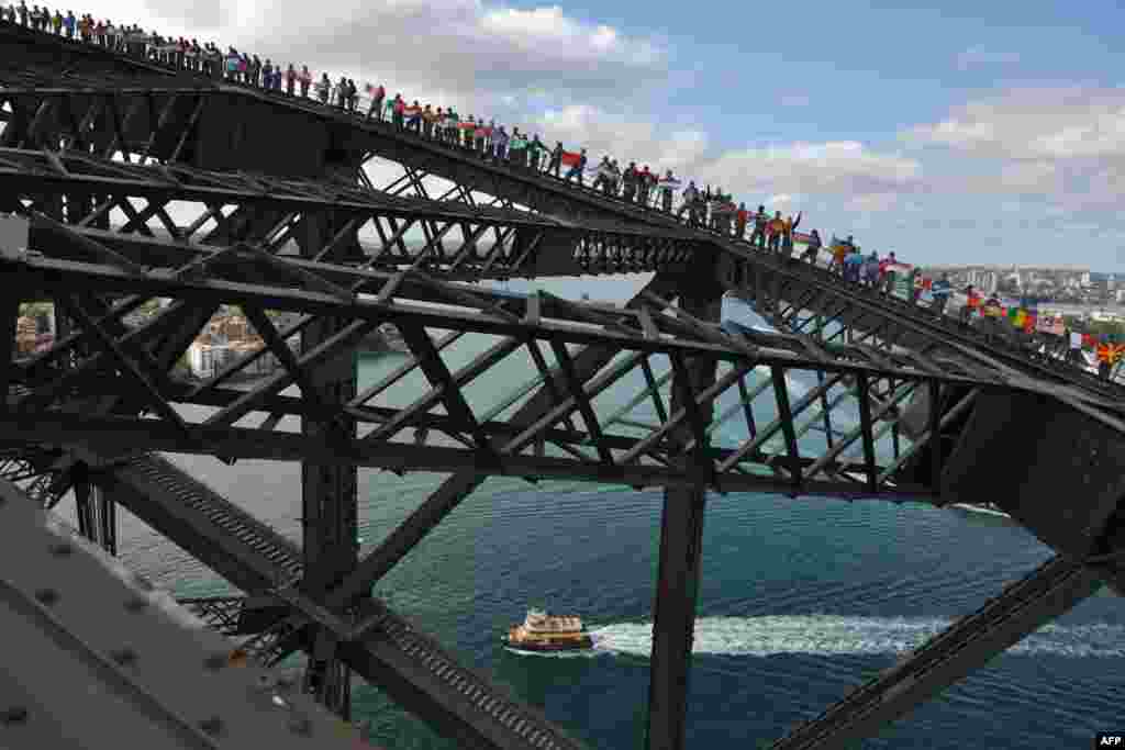 Rotary members and friends climb Sydney Harbour Bridge in an attempt to break the Guiness World Record for the most people on the bridge at one time and the most flags on the bridge at one time in Sydney, Australia. The number of people on the bridge, 340, beat the previous record of 316. The number of different international flags flown, 219, beat the previous record of 143 to raise funds for Rotary&#39;s End Polio Now Campaign.