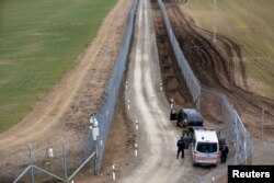 Hungarian police and soldiers patrol the Hungary-Serbia border, which was recently fortified by a second fence, near the village of Gara, Hungary, March 2, 2017.