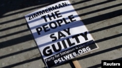 A sign lays on the ground at a protest of the acquittal of George Zimmerman for the 2012 shooting death of Trayvon Martin, in Los Angeles, California July 15, 2013.