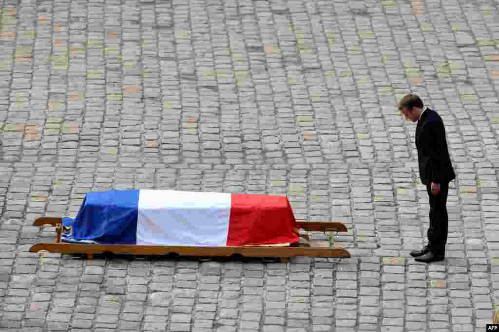 French President Emmanuel Macron pays his respects to the coffin of Hubert Germain during the national memorial service for him — the last surviving Liberation companion — at The Hotel des Invalides in Paris.