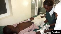 Nurses attend to a victim of the clashes between the pastoralists and farmers within the Tana Delta region, at the Malindi District hospital, Kenya, September 7, 2012. 