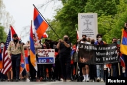 FILE - Members of the Armenian diaspora march to the Turkish Embassy after U.S. President Joe Biden recognized that the 1915 massacres of Armenians in the Ottoman Empire constituted genocide, in Washington, April 24, 2021.