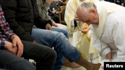 Pope Francis washes the foot of a prisoner at Casal del Marmo youth prison in Rome, Italy, Mar. 28, 2013.