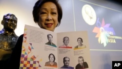 Magsaysay Award Foundation President Carmencita Abella poses with pictures of this years' Magsaysay awardees, regarded as an Asian version of the Nobel Peace Prize, in Manila, Philippines, July 26, 2018.