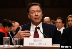 Former FBI Director James Comey testifies before a Senate Intelligence Committee hearing