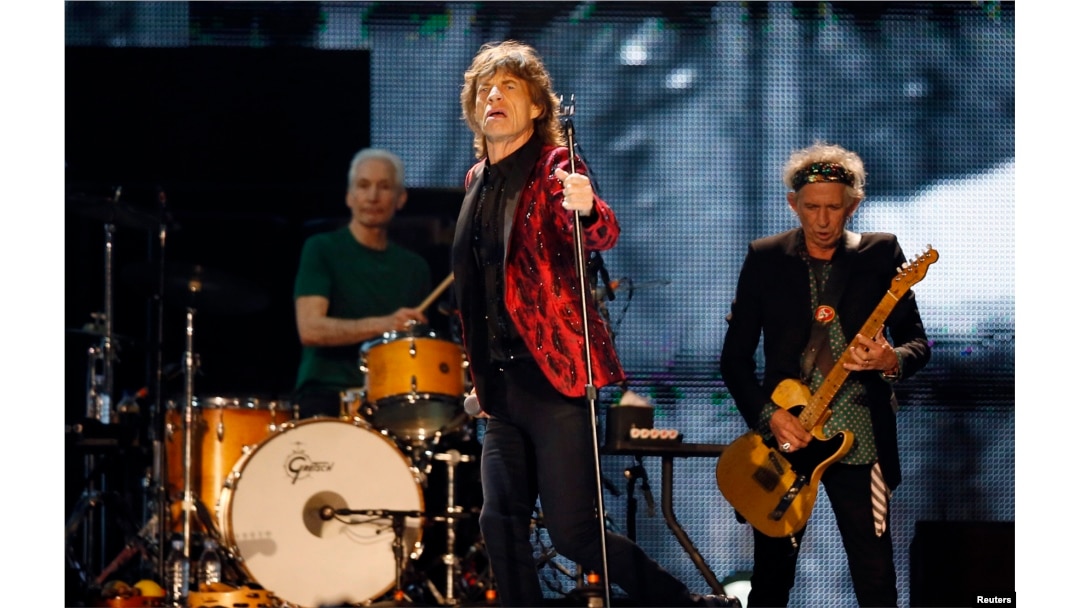 Mick Jagger (C), Charlie Watts (L) and Keith Richards of the Rolling Stones perform during a concert in Abu Dhabi, Feb. 21, 2014.
