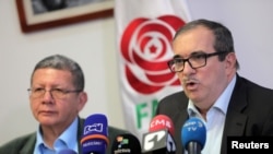 Former rebel leader of Colomobia's Revolutionary Armed Forces of Colombia (FARC) Rodrigo Londono (R), and Pablo Catatumbo, former FARC commander and member of the political party Revolutionary Alternative Common Force (FARC), speak at a news conference in Bogota, May 15, 2019.