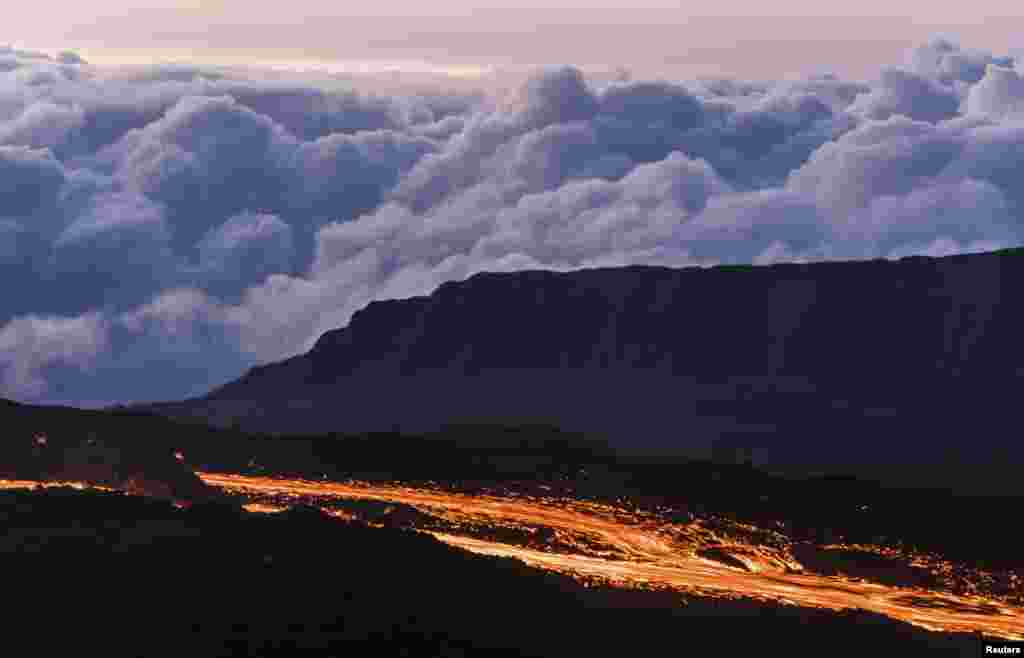 Molten lava flows from the Piton de la Fournaise, one of the world&#39;s most active volcanoes, at dawn on the French Indian Ocean Reunion Island, Aug. 25, 2015.