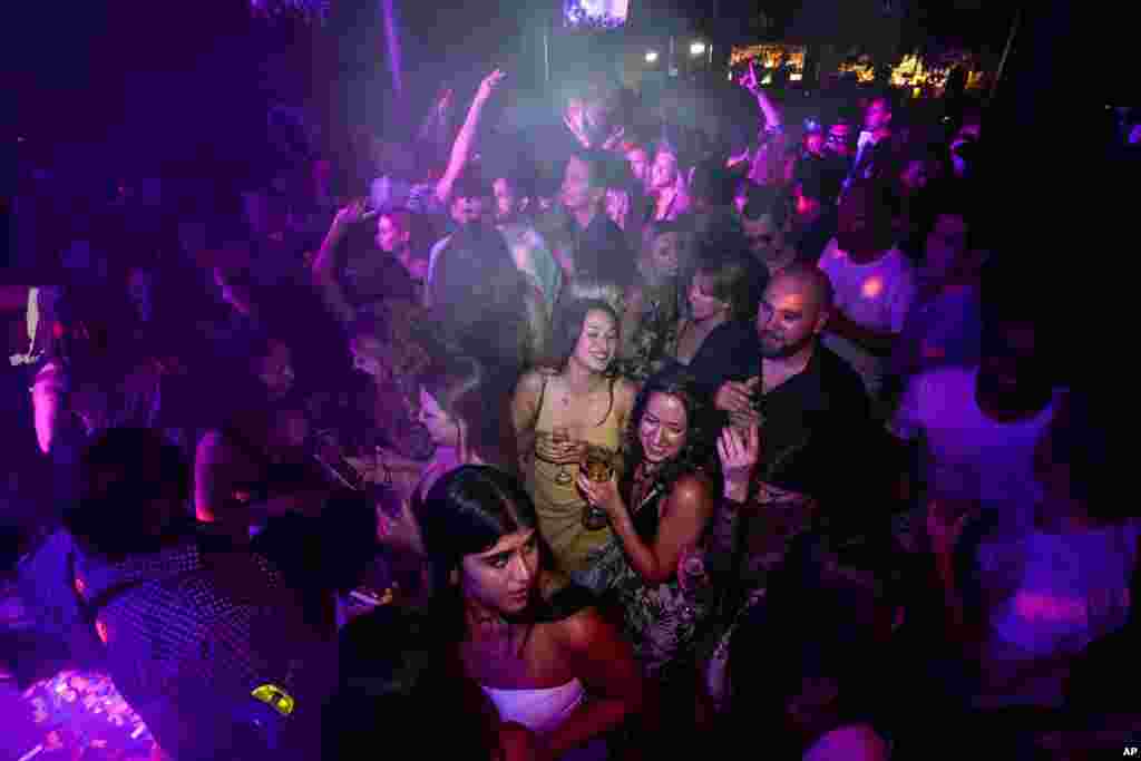 People drink on the dance floor shortly after the reopening at The Piano Works in Farringdon, in London.&nbsp;Thousands of young people plan to dance the night away at &#39;Freedom Day&#39; parties when almost all coronavirus restrictions in England are to be scrapped.