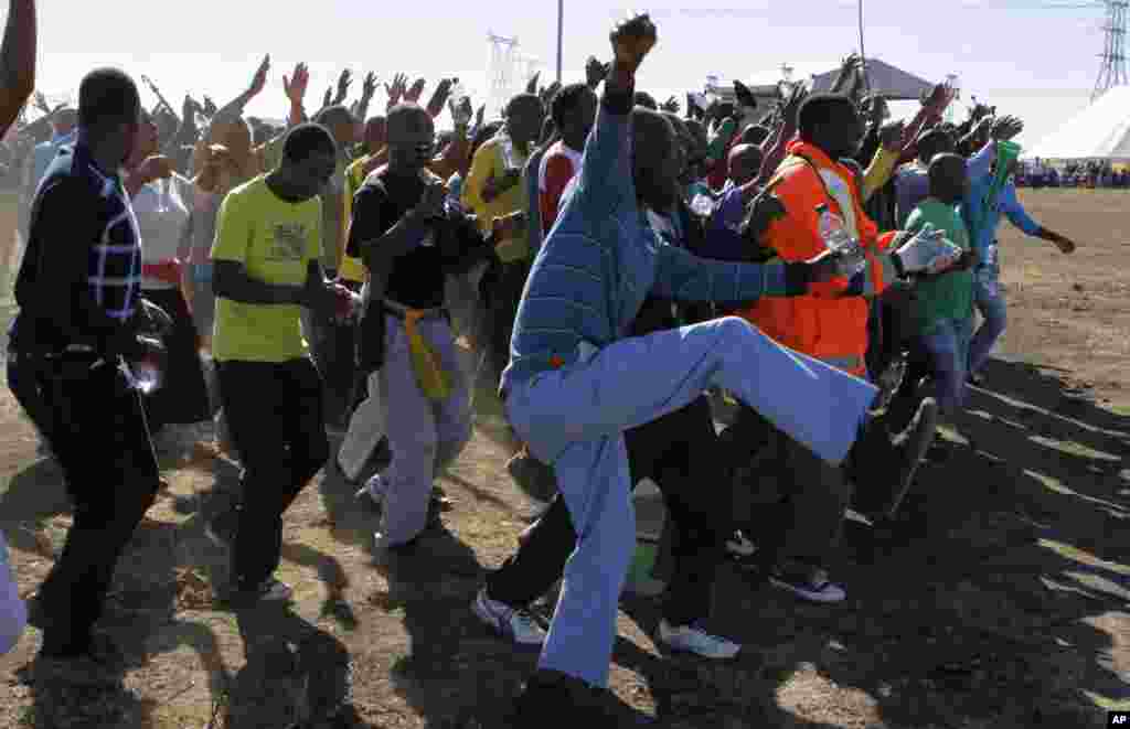 Miners arrive for a commemoration service for the striking platinum miners that were killed a year ago, in Marikana, South Africa, August 16, 2013.