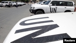 Vehicles belonging to United Nations observers are parked in front of a hotel in Damascus July 2, 2012. 