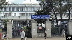 Pedestrians walk past the Federal High Court building in Addis Ababa, Ethiopia, November 1, 2011.