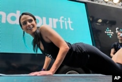 You don't equipment or even much floor space to do some pushups. In this photo, actress Jordana Brewster leads a workout in front of the New York Stock Exchange. (2015 AP Photo)