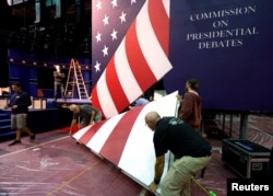 Stage hands install part of the stage for the first U.S. presidential debate at Hofstra University in Hempstead, New York, Sept. 24, 2016.