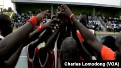 The Black Stars team, which won the inaugural Manute Bol basketball tournament, named after the South Sudanese NBA player who died suddenly in June 2010, huddle before a match.