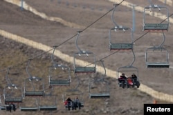 Tourists ride the chairlift at the El Colorado ski center at Los Andes Mountain range, near Santiago, Chile, July 1, 2015.