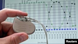 A pacemaker is shown against the backdrop of a cardiological graph in Potsdam, Germany, February 26, 2004.