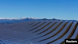 FILE - Solar panels are used to produce renewable energy at the photovoltaic park in Les Mees, in the department of Alpes-de-Haute-Provence, France, March 31, 2015.
