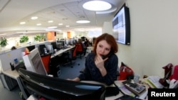 An employee speaks on the phone at the office of the Moscow Exchange, Russia's main venue for trading in stocks, bonds, foreign exchange and derivatives, January 21, 2013.