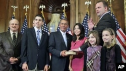 House Speaker John Boehner of Ohio, center, performs the ceremonial swearing-in of Tea Party favorite Rep. Jon Runyan, R-N.J., in Washington, January 5, 2011