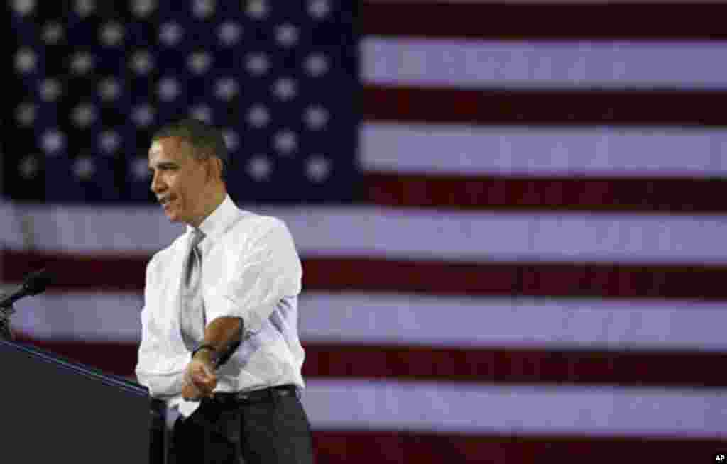 President Barack Obama rolls up his sleeves as he speaks at a campaign fundraiser at the University of Vermont in Burlington, Vt., Friday, March, 30, 2012. (AP Photo/Pablo Martinez Monsivais)