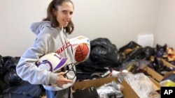Goods4Greatness, the nonprofit started by Rhiannon Potkey, works to get much-needed gear to low-income children and teens to make sure the high cost of equipment doesn't stop their athletic dreams. (AP Photo/Teresa Walker)