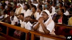 A nun prays during the service at the Our Lady of Consolation Church, which was attacked with grenades by militants almost three years ago, in Garissa, Kenya Sunday, April 5, 2015.