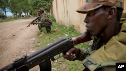 Somali National Army soldiers serving with the AU Mission in Somalia hold defensive positions in the town of Afgoye