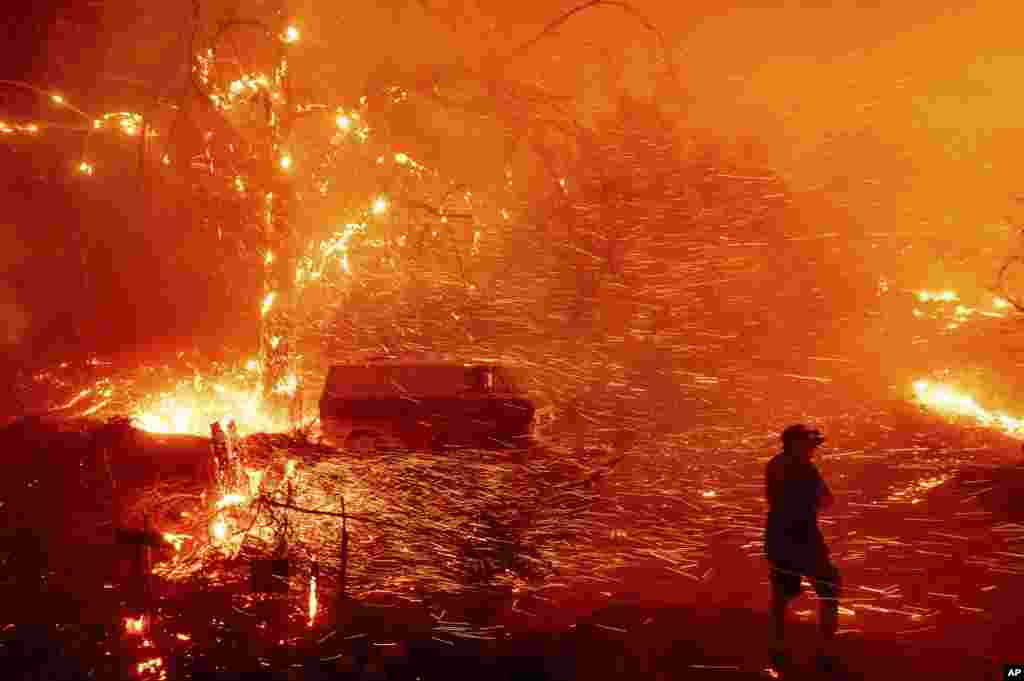 Bruce McDougal prepares to defend his home as the Bond Fire burns though the Silverado community in Orange County, California.