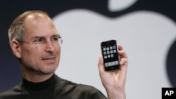 FILE - Apple CEO Steve Jobs holds up an Apple iPhone at the MacWorld Conference in San Francisco, Jan. 9, 2007.