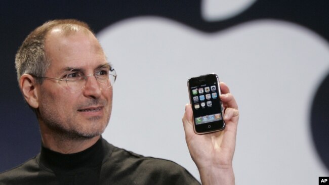 FILE - Apple CEO Steve Jobs holds up an Apple iPhone at the MacWorld Conference in San Francisco, Jan. 9, 2007.