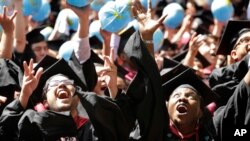 FILE - Students celebrate after graduating from Harvard University on May 28, 2015, in Cambridge, Massachusetts. 