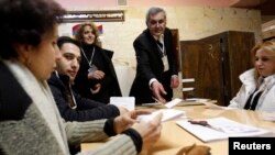 Election officials count ballots after polls closed at a polling station in Yerevan, February 18, 2013. Armenian President Serzh Sarksyan will secure a new five-year term in a election on Monday, an exit poll showed after a vote overshadowed by a lack of 