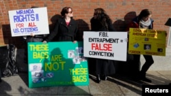 FILE - Demonstrators asserting that evidence in the Boston Marathon bombing was fabricated stand outside the federal courthouse ahead of a pre-trial conference for suspect Dzhokhar Tsarnaev in Boston, Dec. 18, 2014.