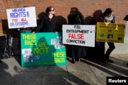 FILE - Demonstrators asserting that evidence in the Boston Marathon bombing was fabricated stand outside the federal courthouse ahead of a pre-trial conference for suspect Dzhokhar Tsarnaev in Boston, Dec. 18, 2014.