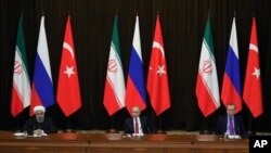 FILE - Turkey's President Recep Tayyip Erdogan, right, Russia's President Vladimir Putin, center, and Iran's President Hassan Rouhani are seen at a news conference following their talks on Syria, in Russia's Black Sea resort of Sochi, Russia, Nov. 22, 2017. The three will be meeting in Ankara, Turkey, Wednesday.
