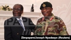 In this handout photos, President Robert Mugabe poses with General Constantino Chiwenga at State House in Harare, Zimbabwe, Nov. 16, 2017. 