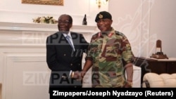 In this handout photos, President Robert Mugabe poses with General Constantino Chiwenga at State House in Harare, Zimbabwe, Nov. 16, 2017. 