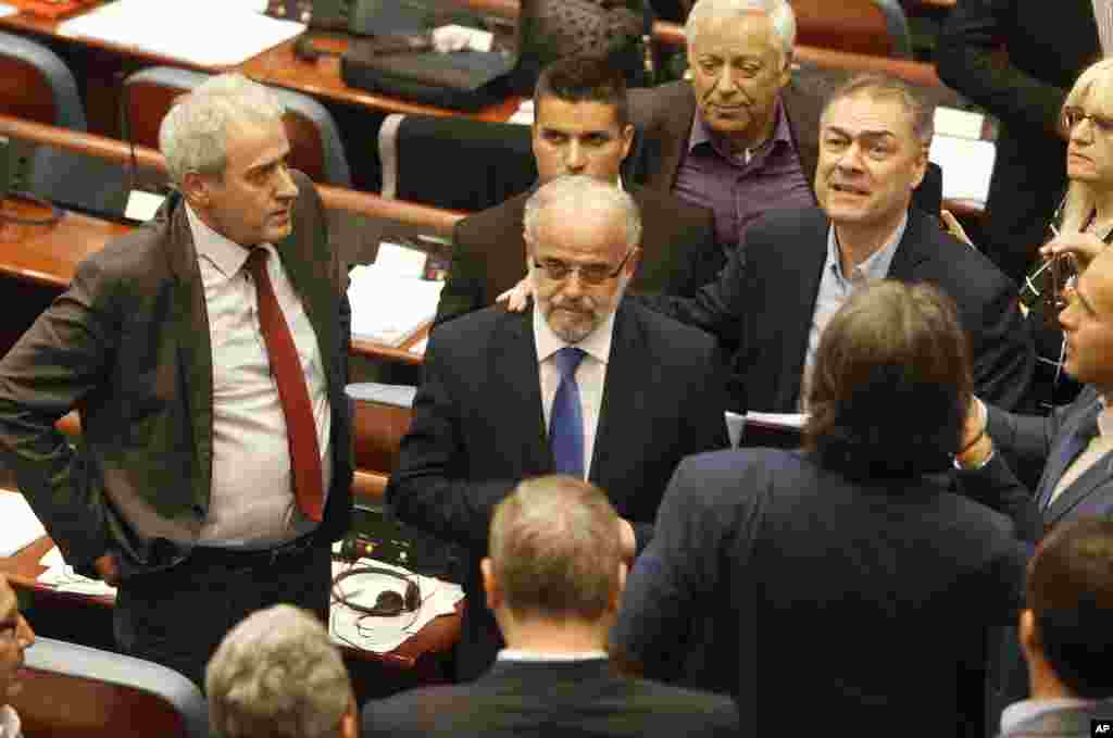 Talat Xhaferi, center, a senior official of the ethnic Albanian Democratic Union for Integrations, stands after being elected as a new speaker in the parliament building in Skopje, Macedonia, April 27, 2017. 