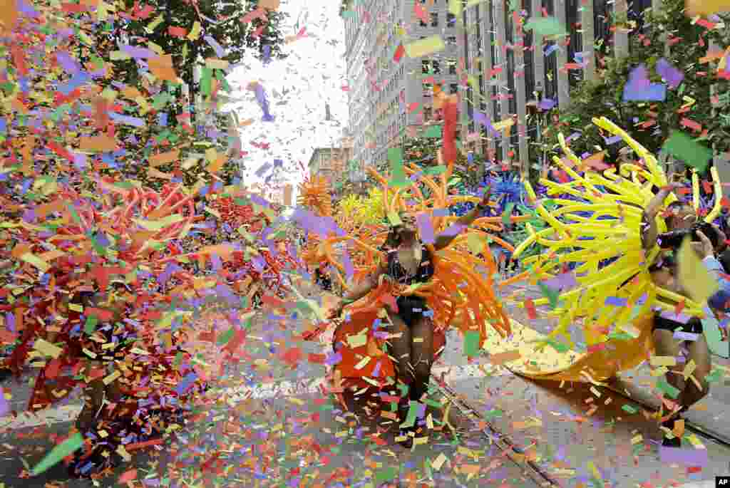 Confetti falls over SF Balloon Magic marchers during the Pride parade in San Francisco, June 25, 2017. 