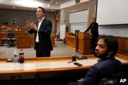 Lorenzo Vidino, of Milan, Italy, top left, director of the Program on Extremism at George Washington University, addresses an audience during a meeting titled "Resilience to Violent Extremism: Effective Intervention Approaches," at Suffolk Law School, in