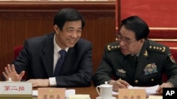 Bo Xilai, left, Chongqing's disgraced Communist Party leader, chats with Xu Caihou, vice chairman of China's Central Military Commission, at the People's Political Consultative Conference in the Great Hall of the People in Beijing, China, March 3, 2010. 