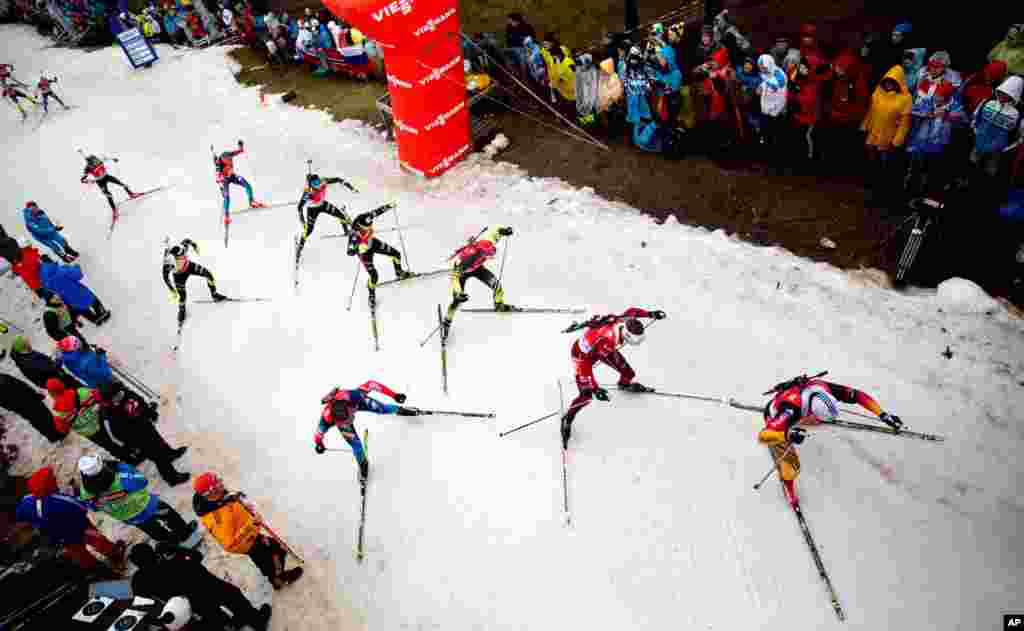 Athletes ski during the men&#39;s 15-kilometer mass start at the biathlon World Cup in Oberhof, Germany.