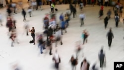 In this June 15, 2017, file photo, people walk inside the Oculus, the new transit station at the World Trade Center in New York. (AP Photo/Frank Franklin II, File)