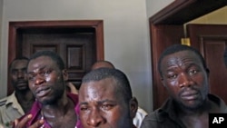 African migrant workers whom rebels accused of being mercenaries seen detained in a military base in Tripoli, Libya, Sunday, Aug. 28, 2011. Hundreds of migrant workers remain stranded in Libya after months of war unable to flee the country. (AP Photo/Serg