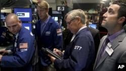 Traders work on the floor at the New York Stock Exchange in New York, Oct. 31, 2012. 