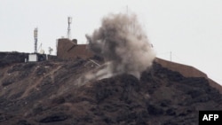Smoke billows from a hilltop during clashes between fighters from Yemen's southern separatist movement and forces loyal to the Saudi-backed president in the country's second city of Aden, Jan. 28, 2018.